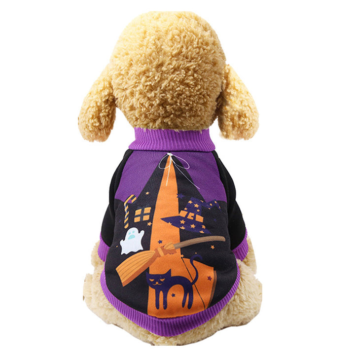 Dog wearing a Halloween-themed sweater with a witch hat, black cat, and ghost design on a white background.