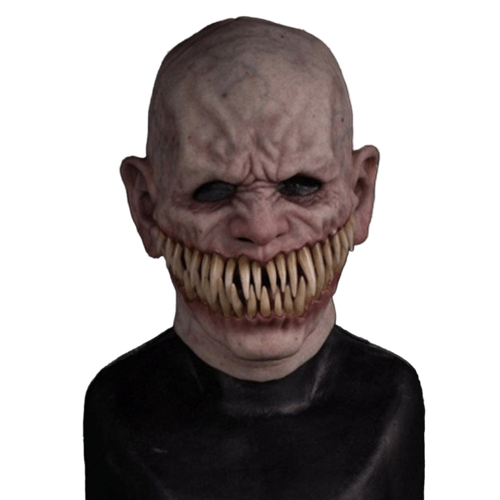 Creepy mask with large teeth on a black background